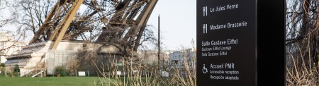 Photo of the gardens of the Eiffel Tower with signage